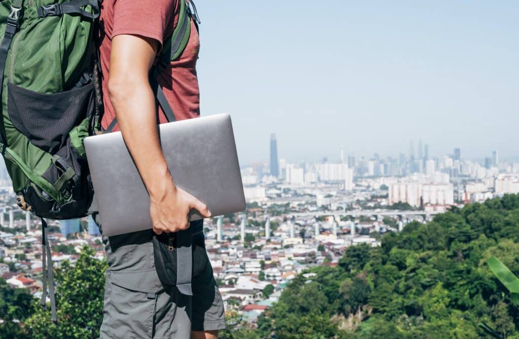 Unrecognizable digital nomad man traveling the world working